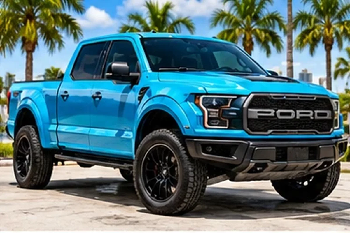 Turquoise wrapped Ford Raptor pickup with off-road tires