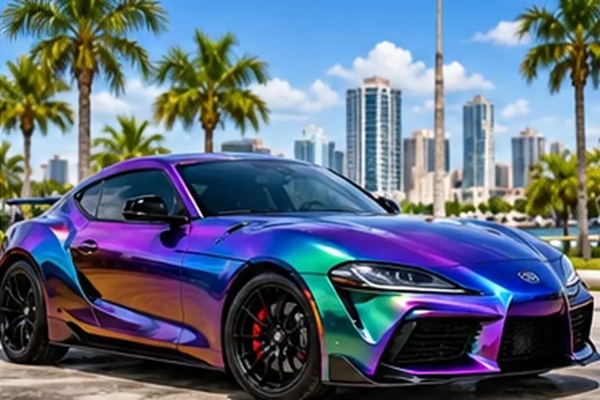 Color-shift purple and teal wrapped sport sedan against the Tampa skyline